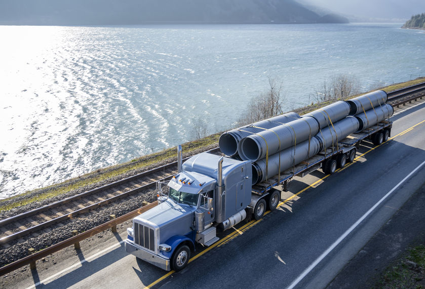 freighter truck carrying piping